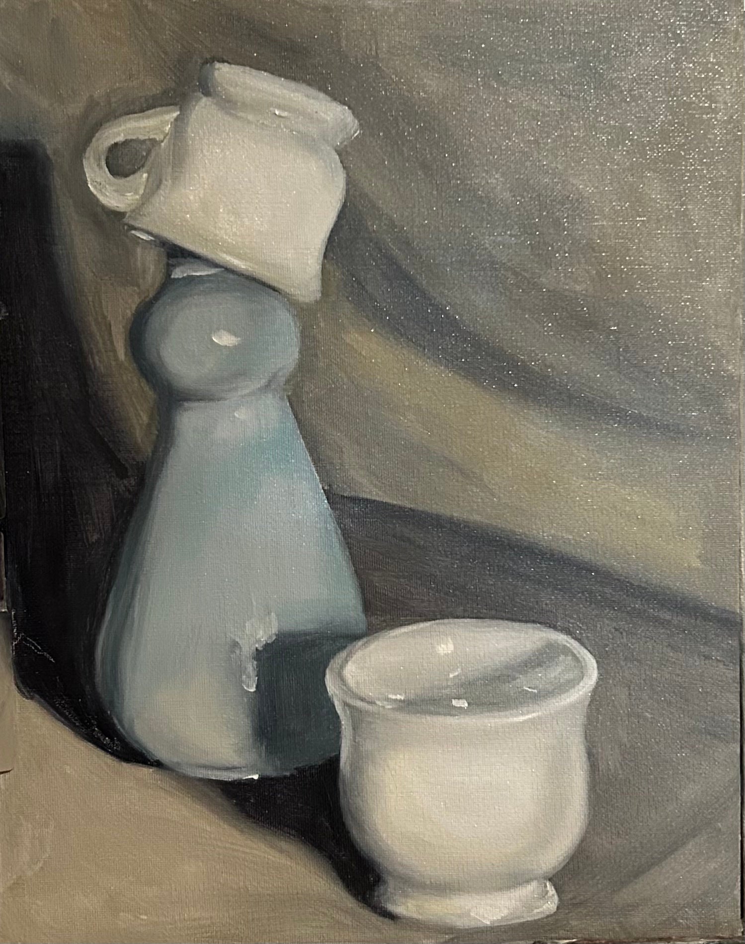 Three ceramic items on a textured surface
