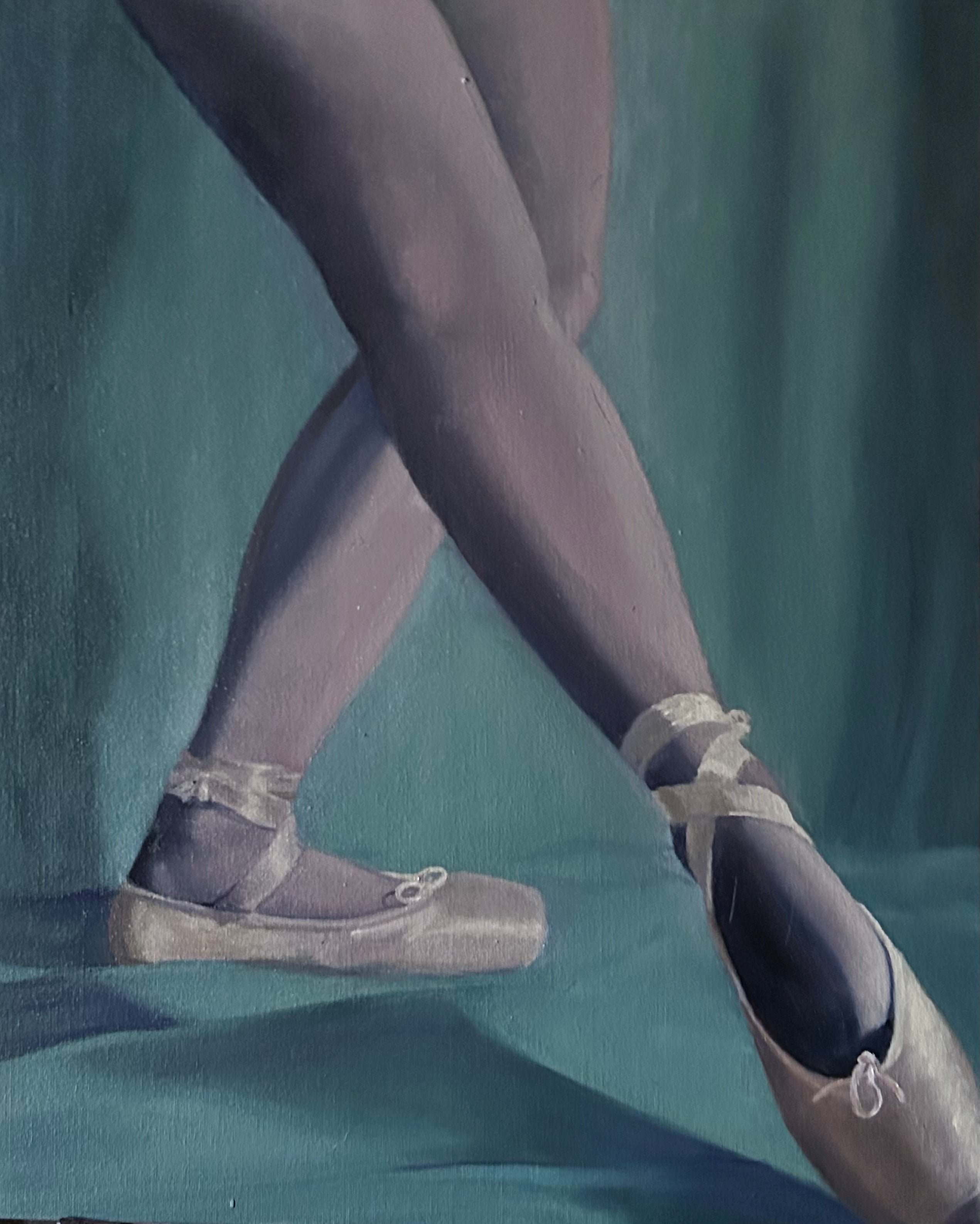 Ballet dancer's feet in pointe shoes with tights on a teal background